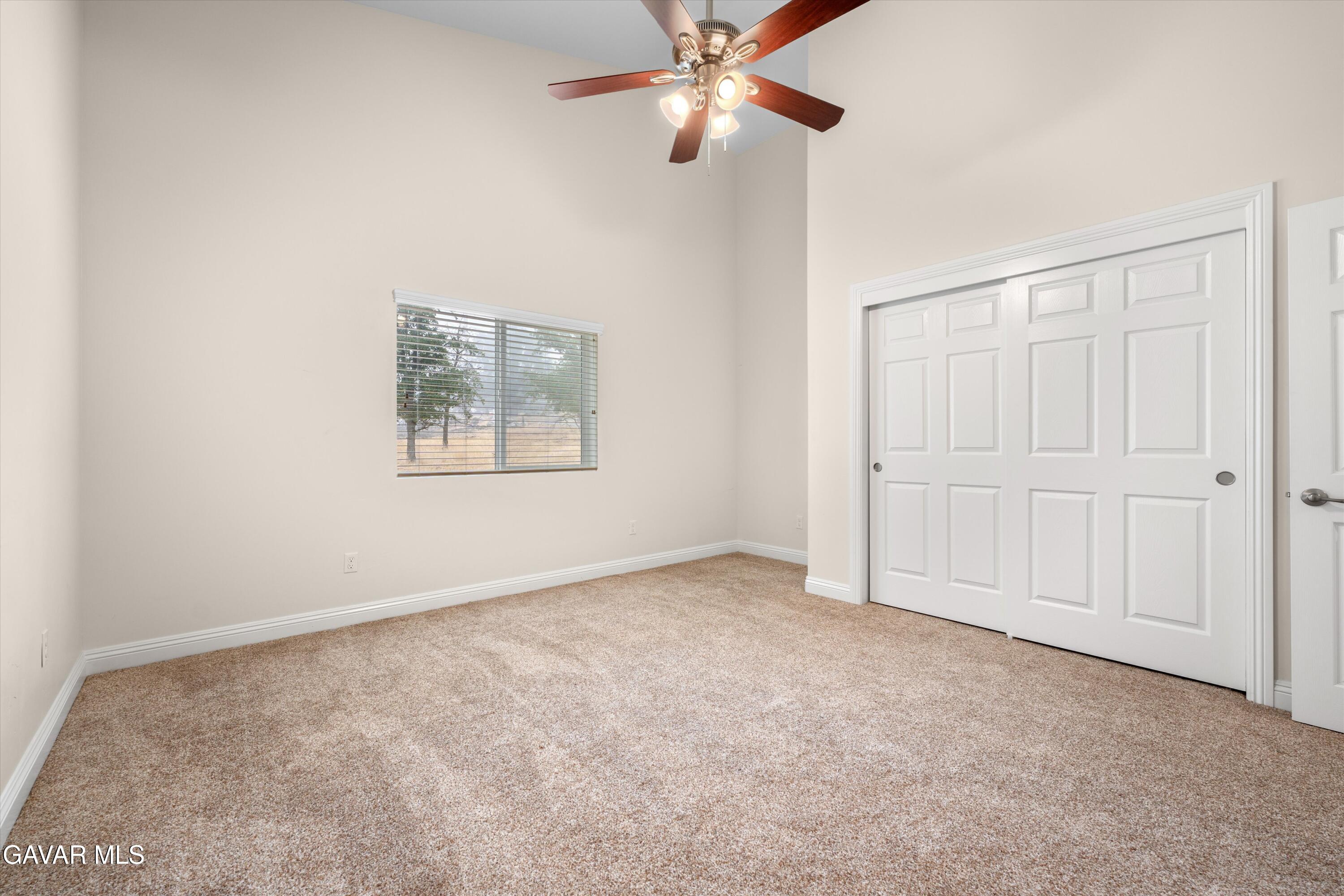 17841 Hambletonian Drive Tehachapi, CA 93561 - Photo 7 of 22 an empty room with windows and fan