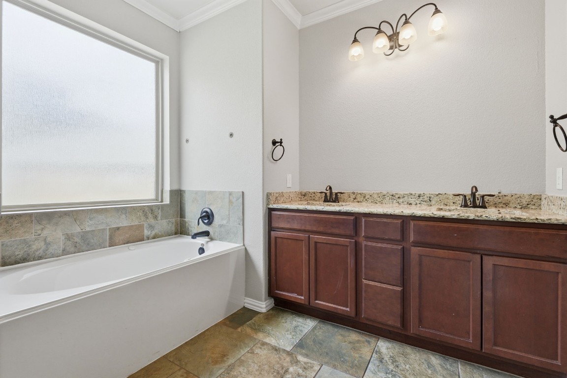 7 Maple Mill Court Conroe, TX 77301 - Photo 12 of 20 a bathroom with a granite countertop tub sink and mirror