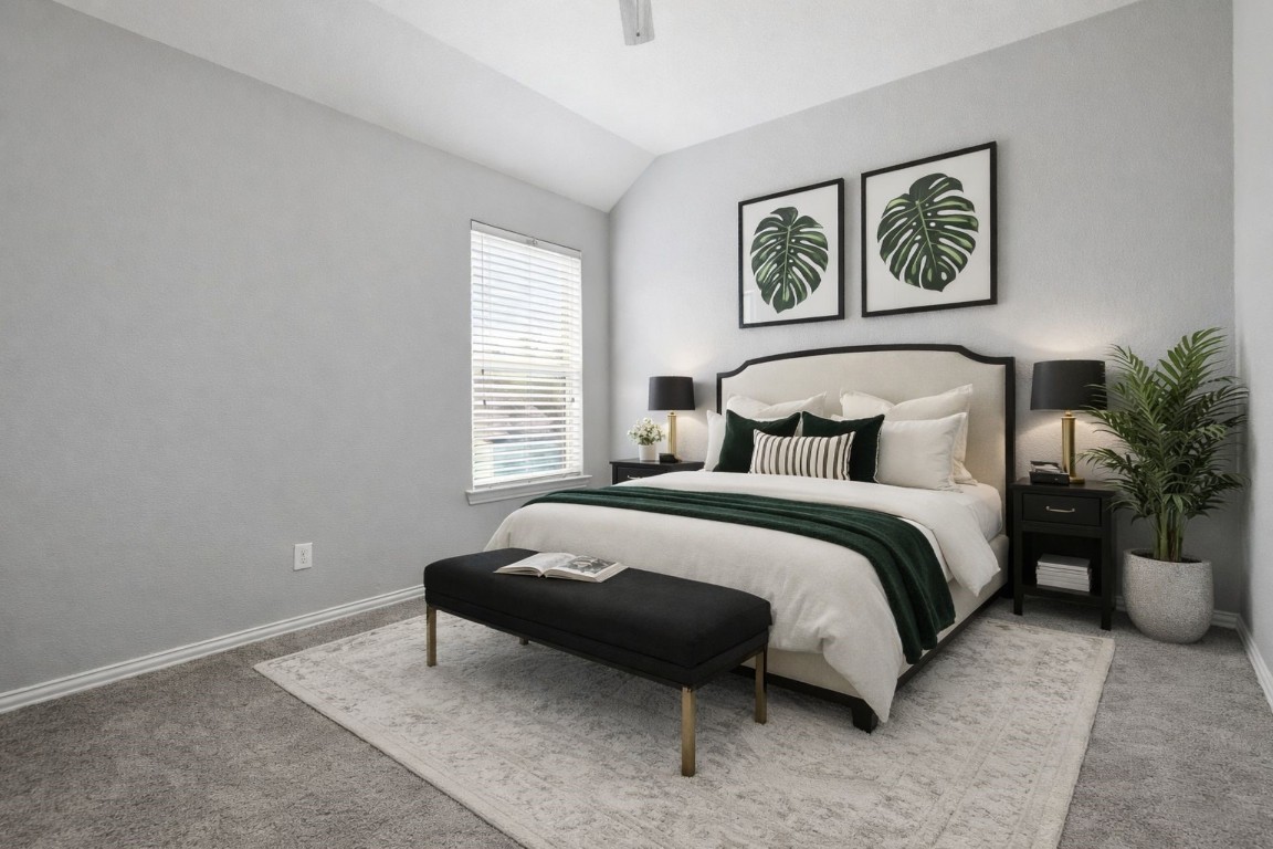 7 Maple Mill Court Conroe, TX 77301 - Photo 13 of 20 a bedroom with a bed and a painting on the wall
