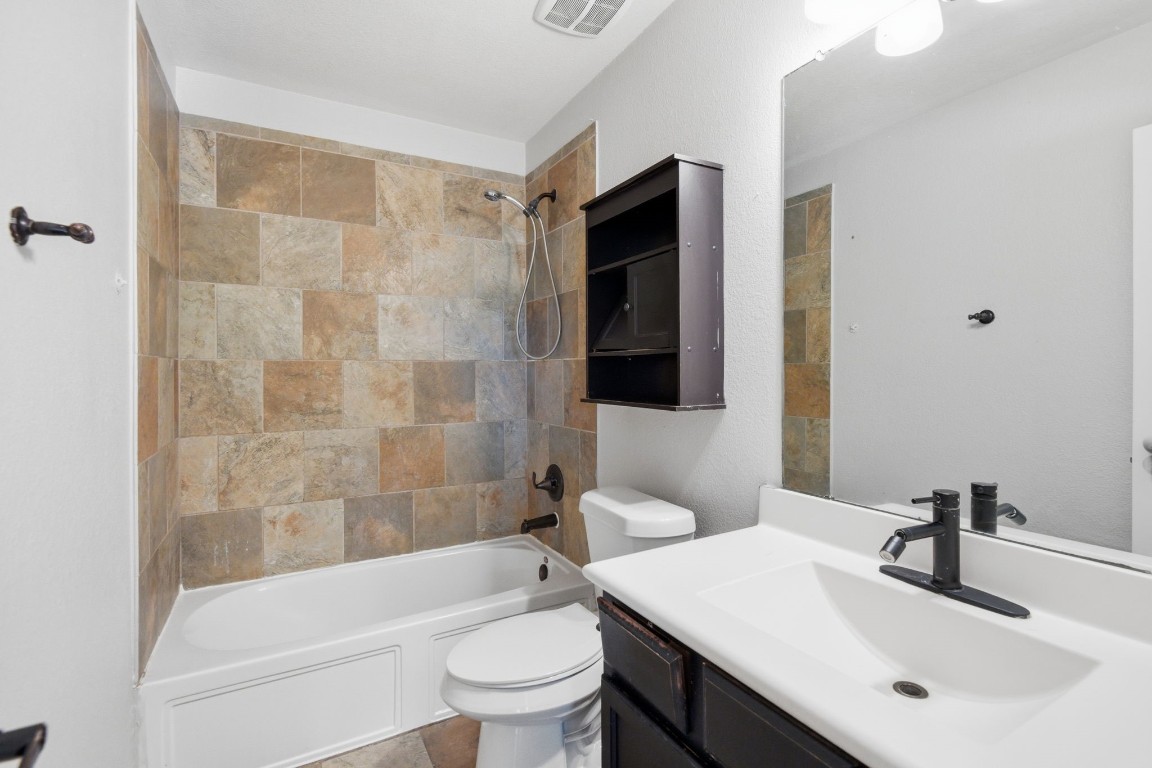 7 Maple Mill Court Conroe, TX 77301 - Photo 14 of 20 a bathroom with a sink toilet and shower