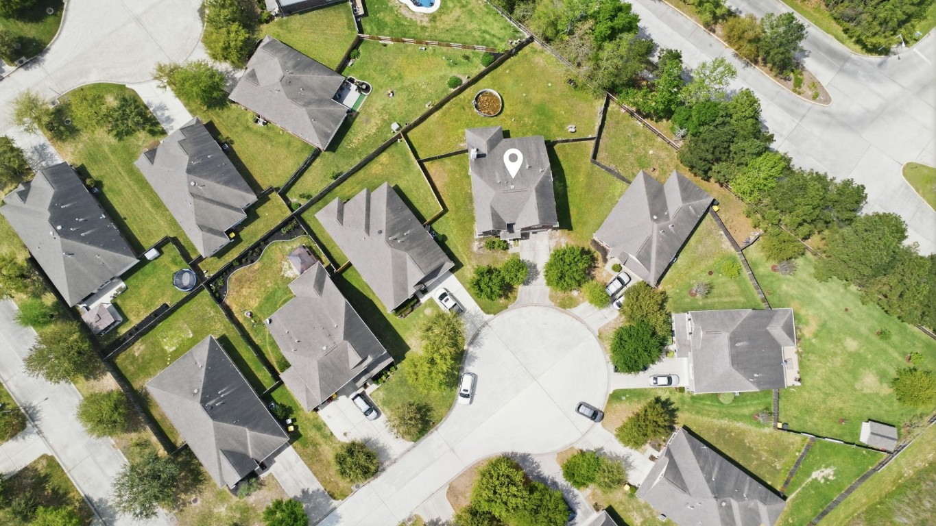 7 Maple Mill Court Conroe, TX 77301 - Photo 20 of 20 an aerial view of a house with large trees