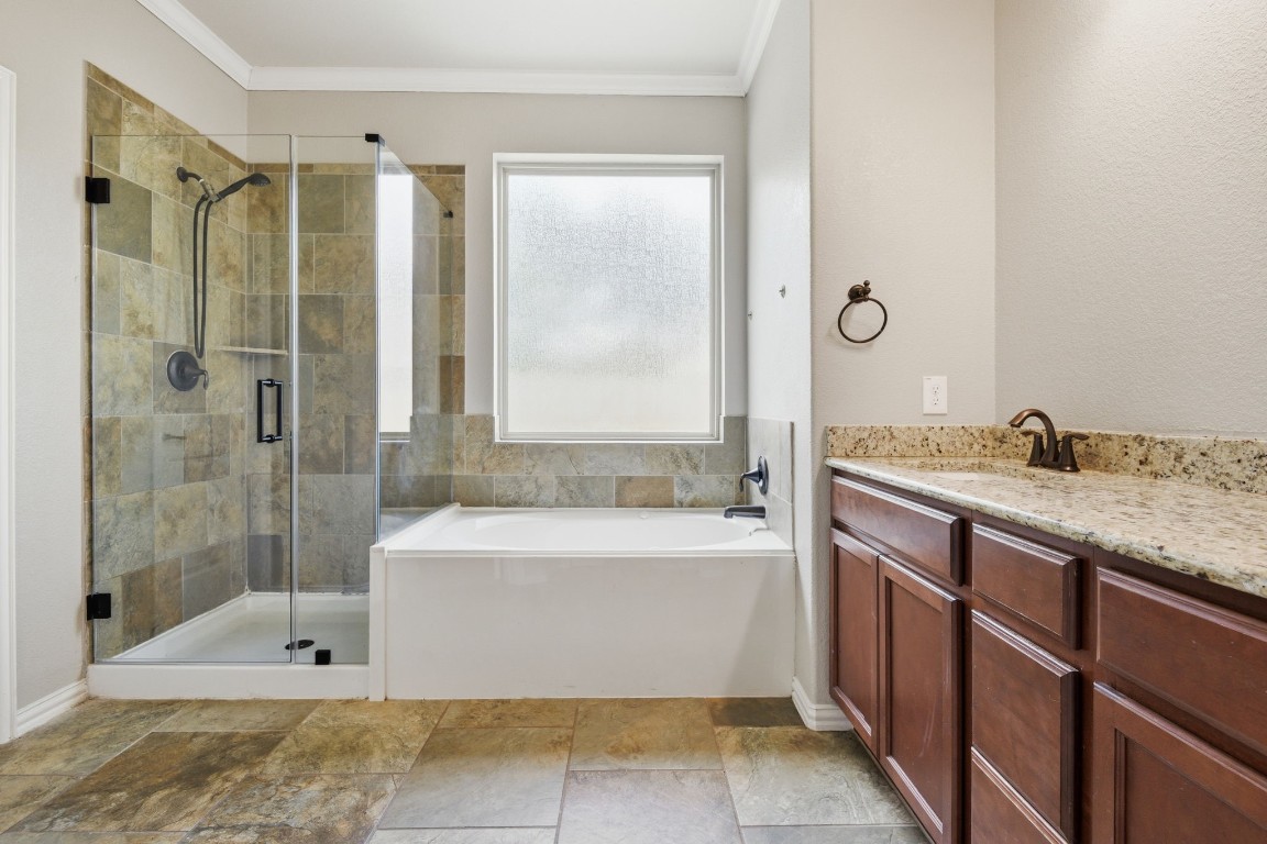 7 Maple Mill Court Conroe, TX 77301 - Photo 10 of 20 a bathroom with a granite countertop sink mirror bathtub and shower