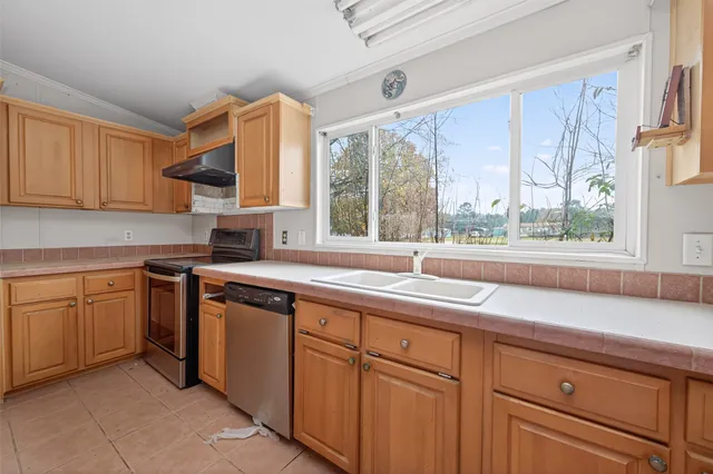 a kitchen with a stove a refrigerator and cabinets