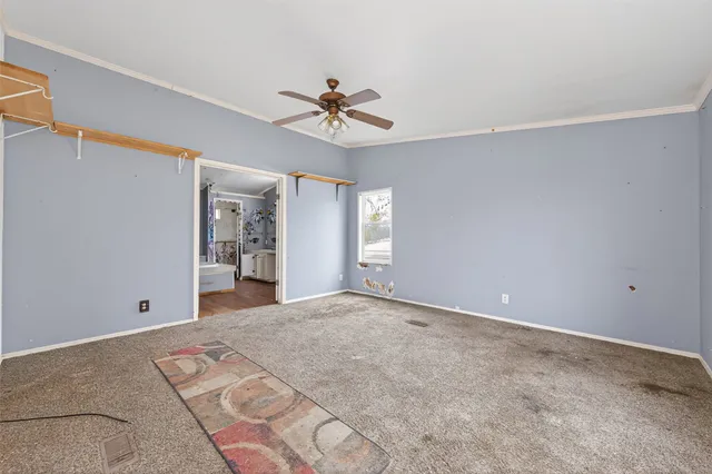 a view of a big room with closet and windows