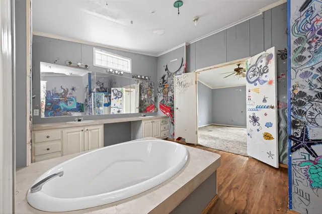 a bathroom with a sink a bathtub and a window