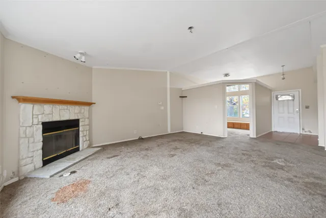 a view of empty room with a fireplace