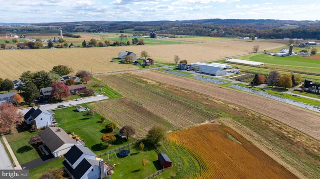 an aerial view of a house with a lake view