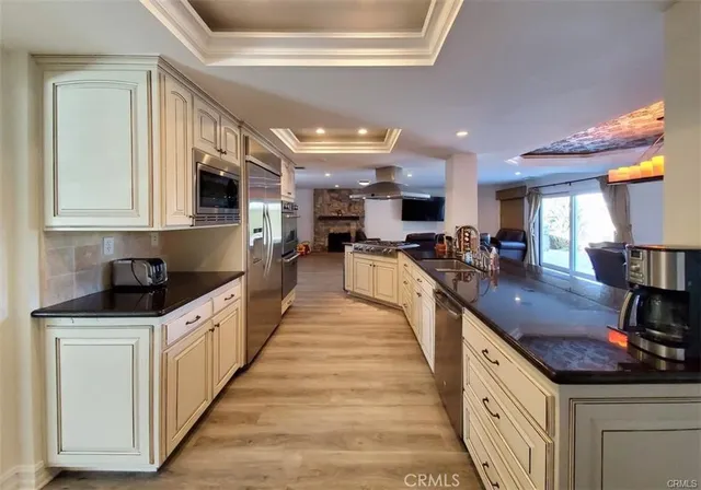 a kitchen with stainless steel appliances granite countertop a stove and a sink