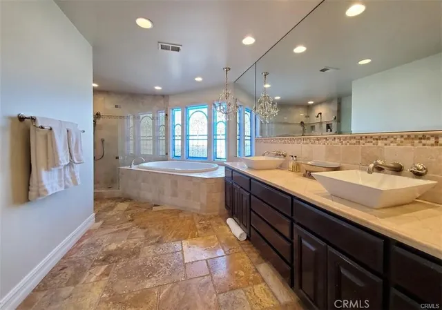 a spacious bathroom with a sink mirror and a bath tub