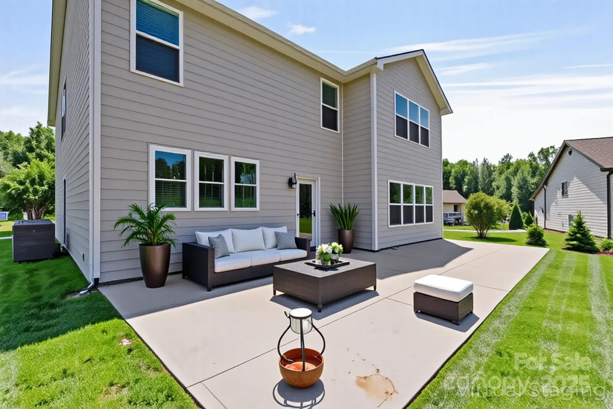 7129 Dove Field Lane Fort Mill, SC 29707 - Photo 12 of 27 a view of a house with backyard sitting area and swimming pool