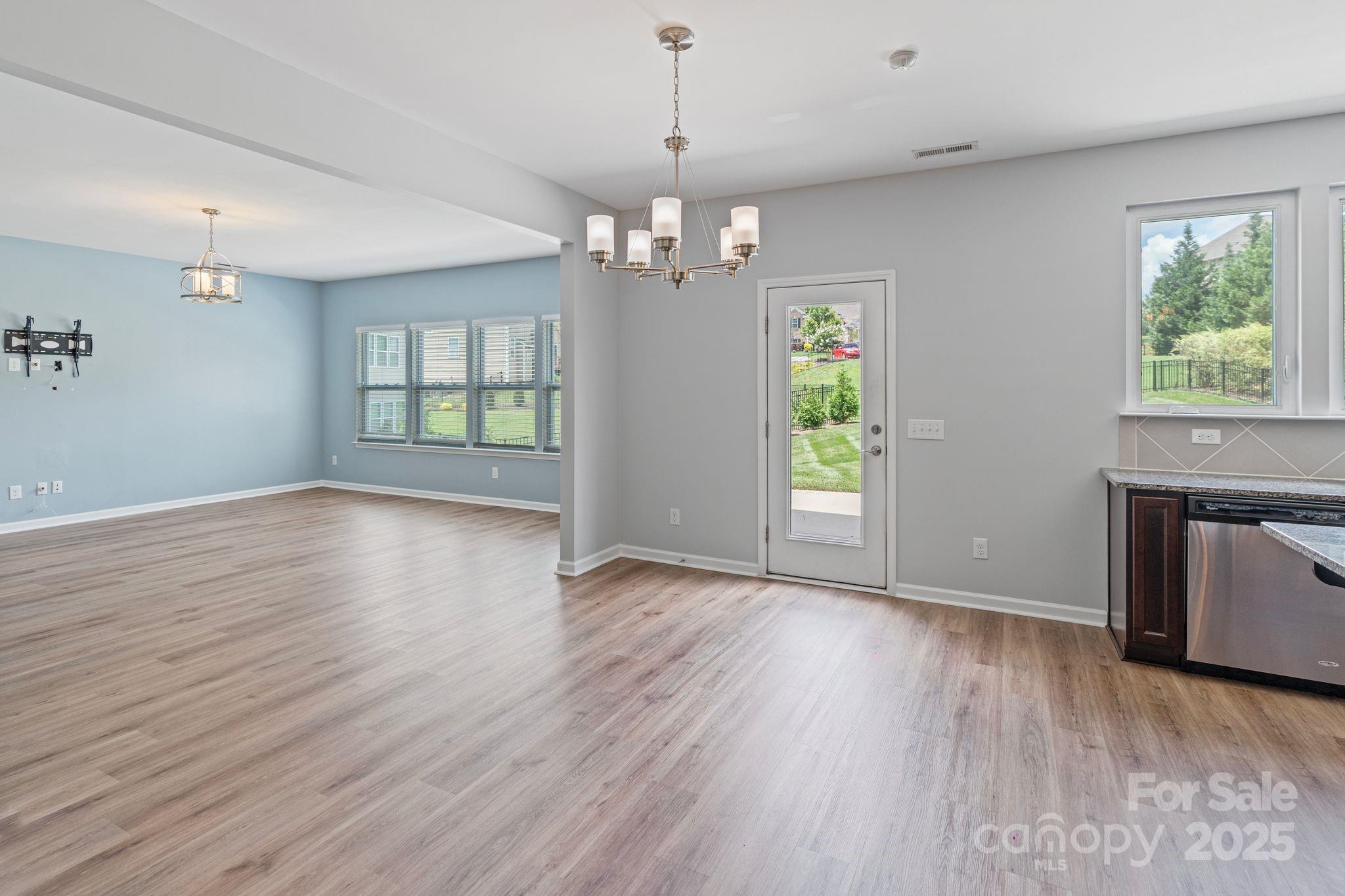7129 Dove Field Lane Fort Mill, SC 29707 - Photo 18 of 27 a view of an empty room with wooden floor and a window