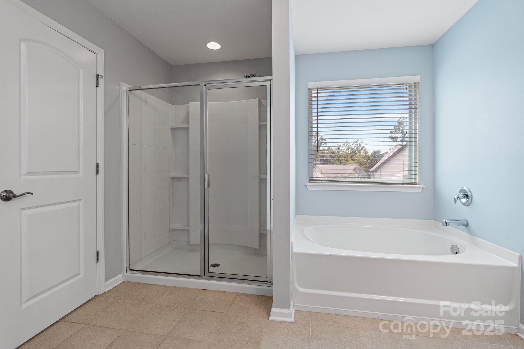 7129 Dove Field Lane Fort Mill, SC 29707 - Photo 21 of 27 a bathroom with a bathtub and a shower