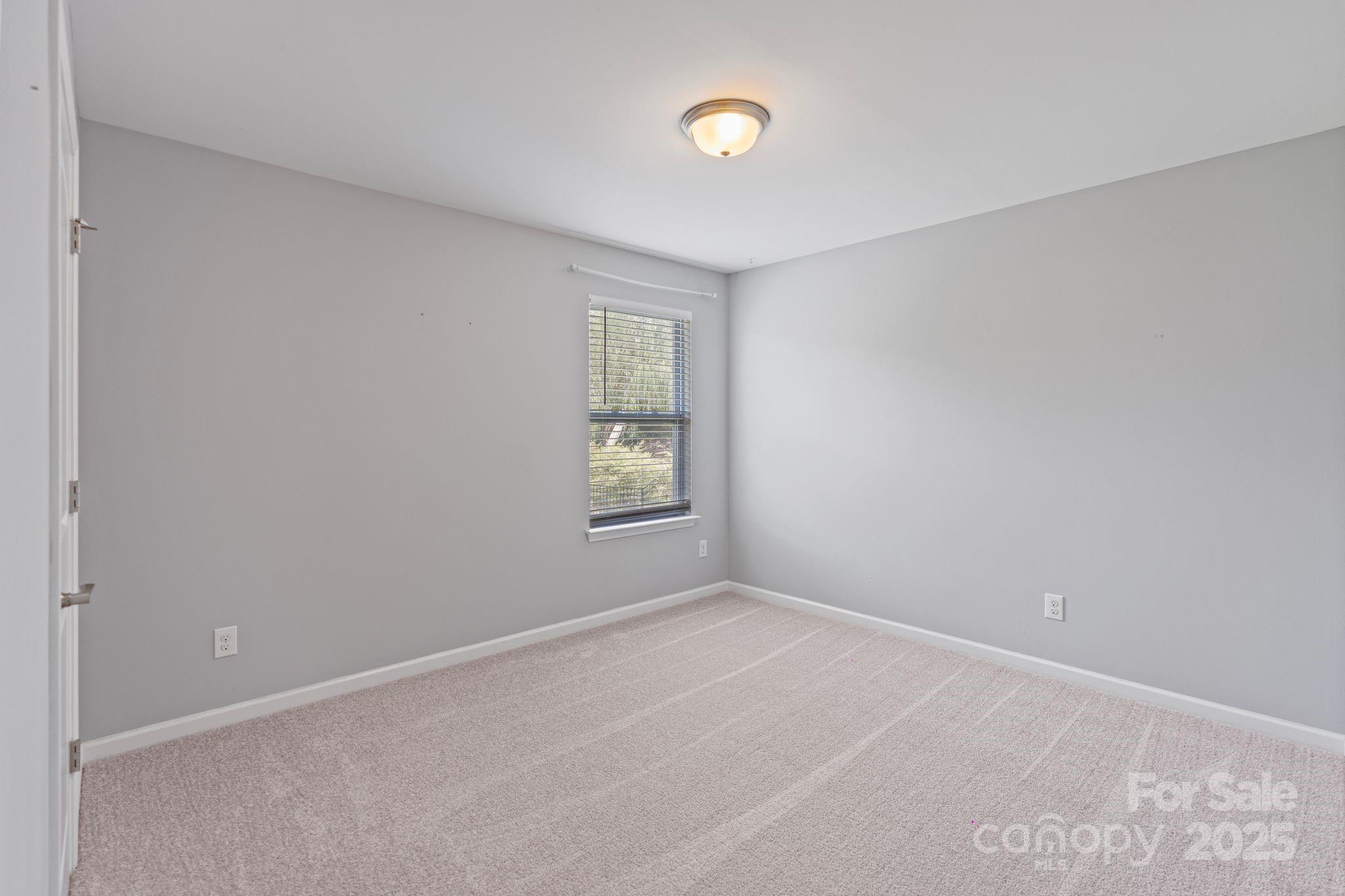 7129 Dove Field Lane Fort Mill, SC 29707 - Photo 25 of 27 an empty room with windows