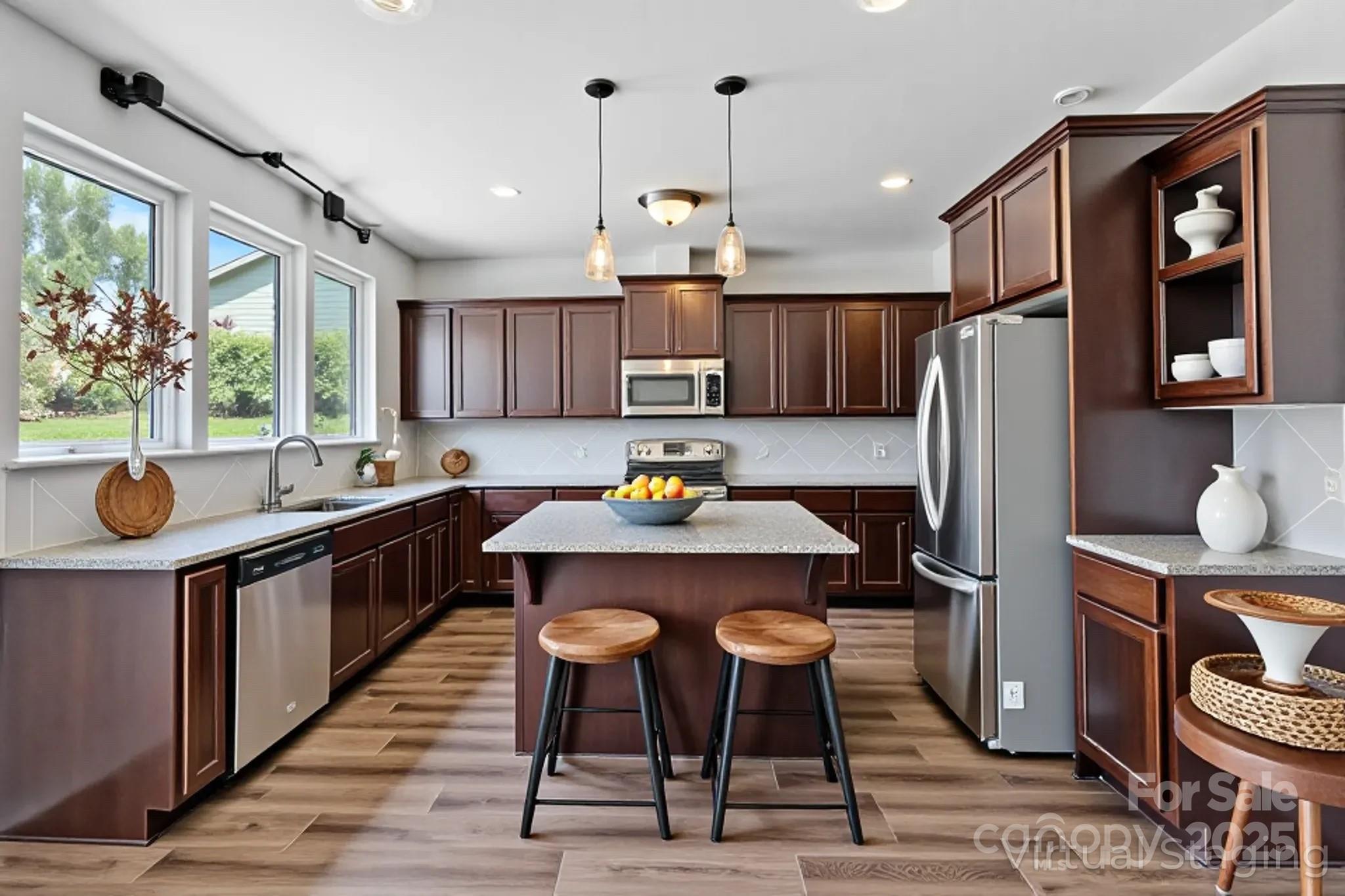 7129 Dove Field Lane Fort Mill, SC 29707 - Photo 5 of 27 a kitchen with stainless steel appliances granite countertop a sink refrigerator and chairs