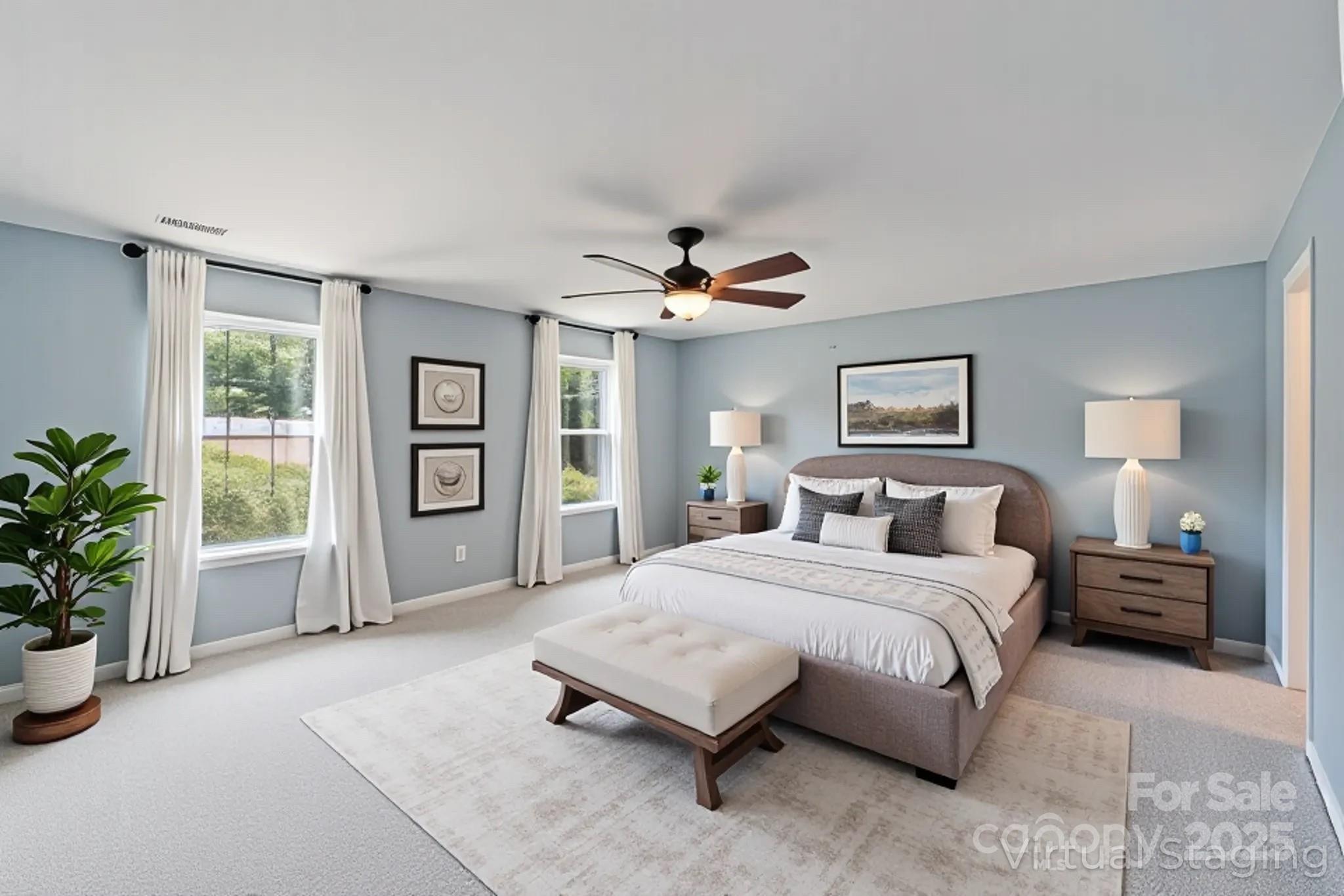 7129 Dove Field Lane Fort Mill, SC 29707 - Photo 10 of 27 a spacious bedroom with a large bed a chandelier and windows