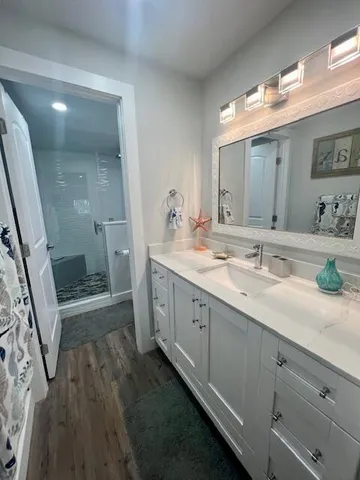 a bathroom with a double vanity sink and mirror