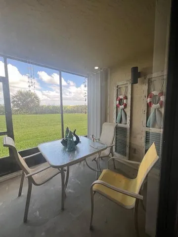 a view of a dining room with furniture and window