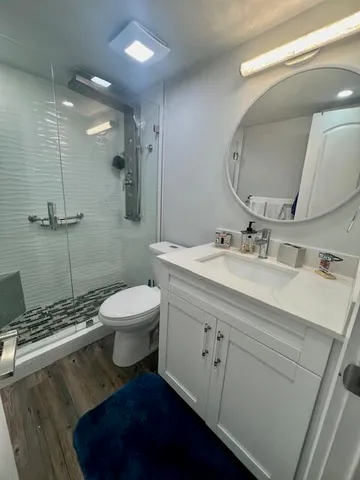 a bathroom with a sink toilet and shower
