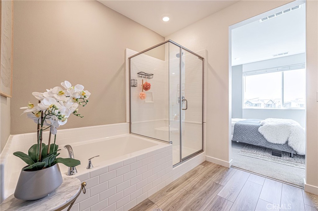 27555 Sanctuary Court Stevenson Ranch, CA 91381 - Photo 12 of 22 a bath room with a bathtub and a shower