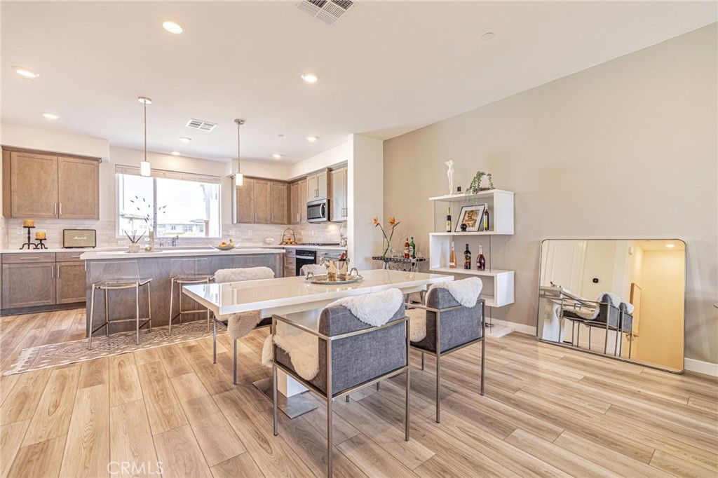 27555 Sanctuary Court Stevenson Ranch, CA 91381 - Photo 6 of 22 a large white kitchen with a large window and counter space