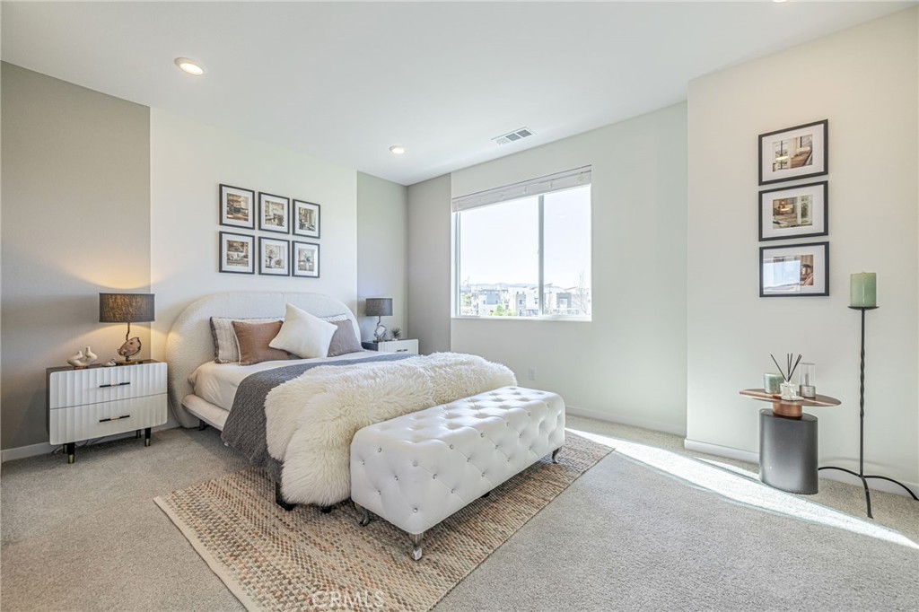 27555 Sanctuary Court Stevenson Ranch, CA 91381 - Photo 10 of 22 a spacious bedroom with a bed and a couch
