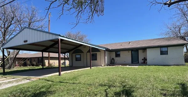 a view of a house with a yard and garage