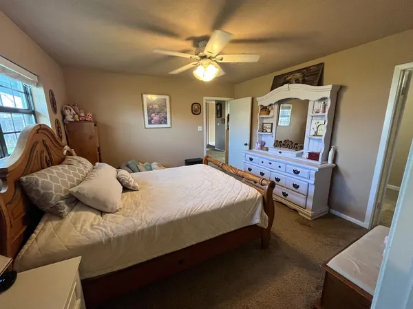 a bedroom with bed and a chandelier