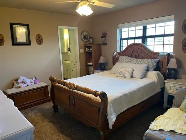 a bedroom with furniture and a chandelier