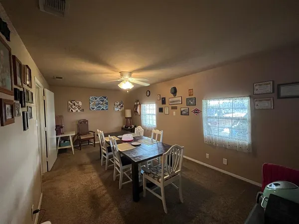 a view of a dining room with furniture and window