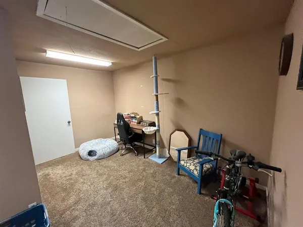 a kitchen with a refrigerator and white cabinets