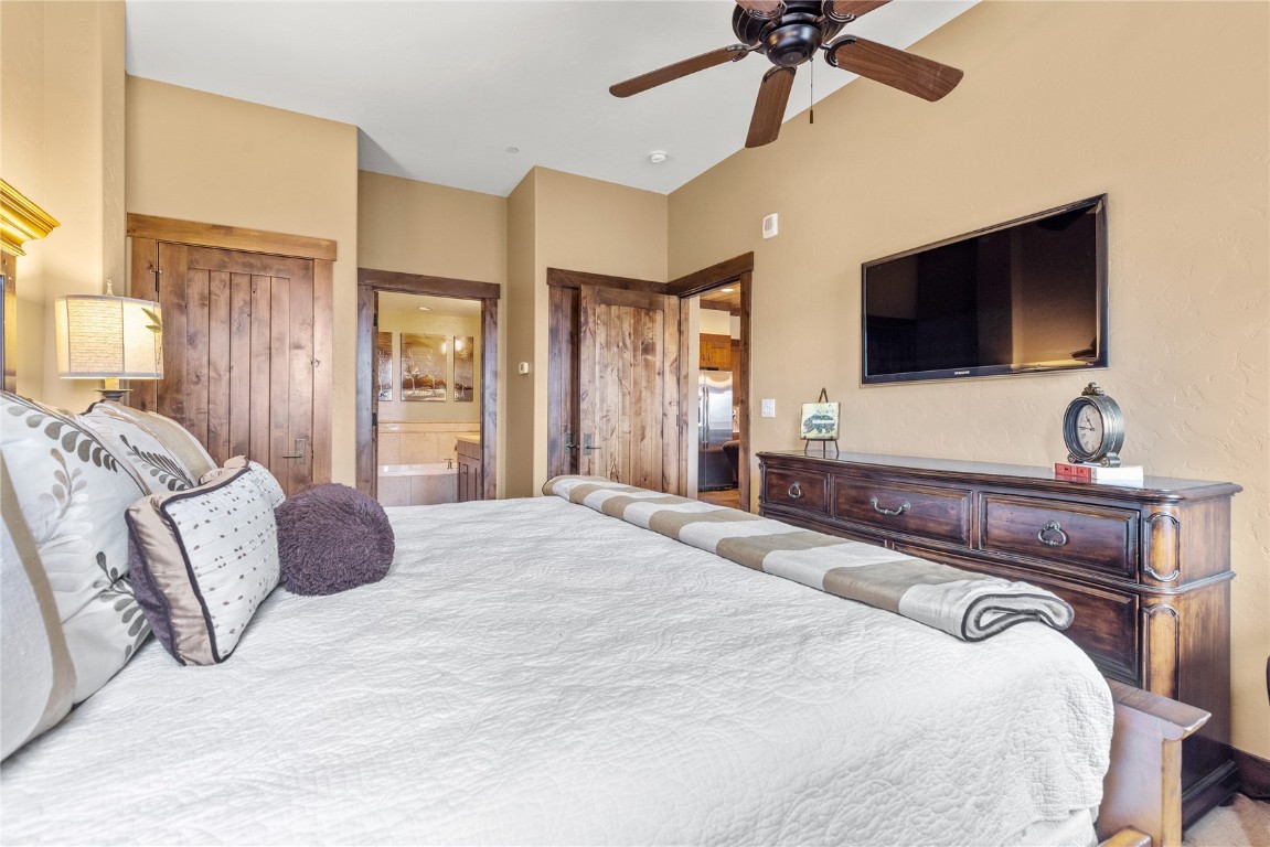 600 Columbine Road, Unit 5407 Breckenridge, CO 80424 - Photo 14 of 29 a bedroom with a bed and a flat screen tv