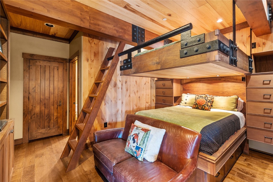 600 Columbine Road, Unit 5407 Breckenridge, CO 80424 - Photo 17 of 29 a bedroom with a bed and wooden floor