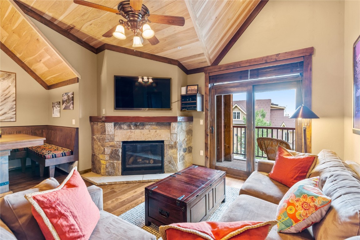 600 Columbine Road, Unit 5407 Breckenridge, CO 80424 - Photo 3 of 29 a living room with furniture a fireplace and a flat screen tv