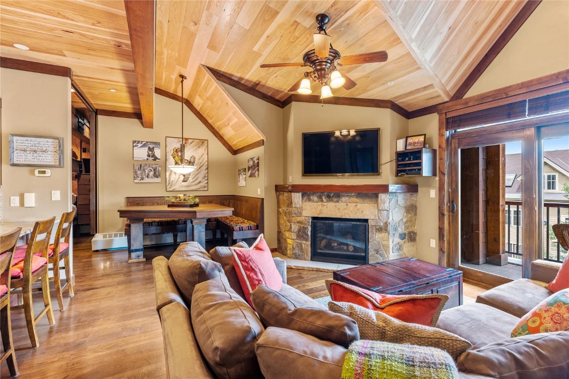 600 Columbine Road, Unit 5407 Breckenridge, CO 80424 - Photo 6 of 29 a living room with furniture a fireplace and a flat screen tv