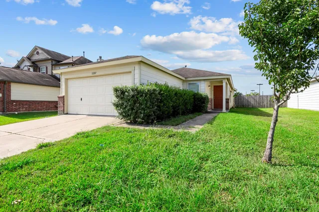 a front view of a house with a yard and garage