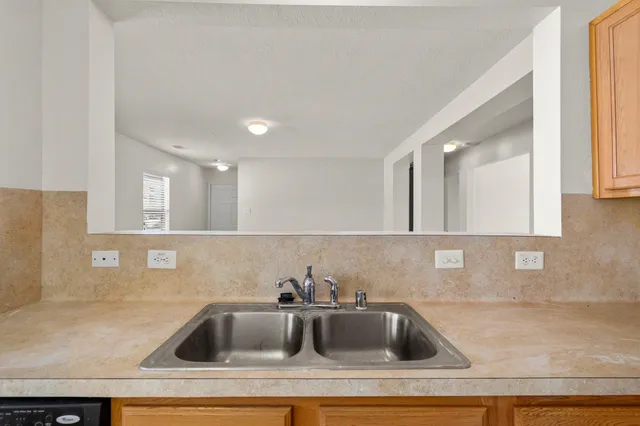 a kitchen with a sink and cabinets