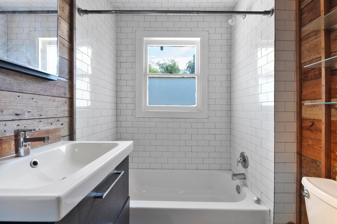 1147 Gunter Street Austin, TX 78721 - Photo 11 of 25 a white bath tub sitting next to a white sink