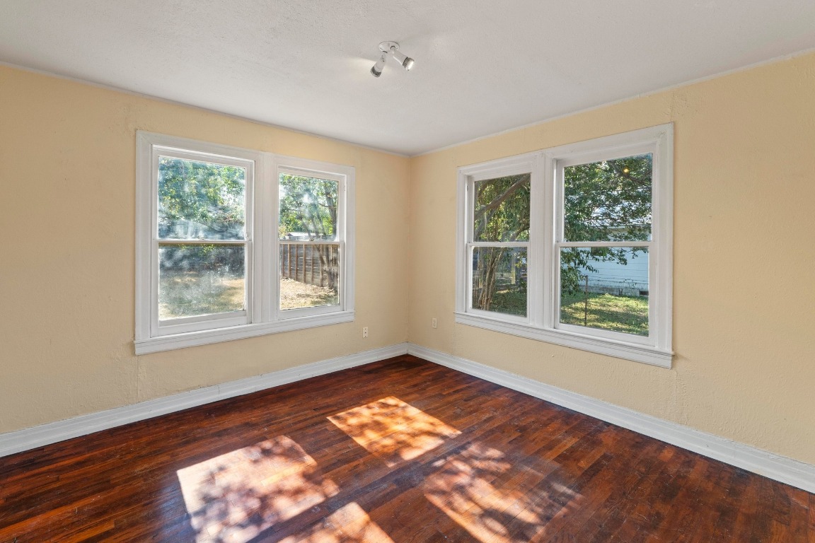 1147 Gunter Street Austin, TX 78721 - Photo 12 of 25 a view of an empty room with wooden floor and a window