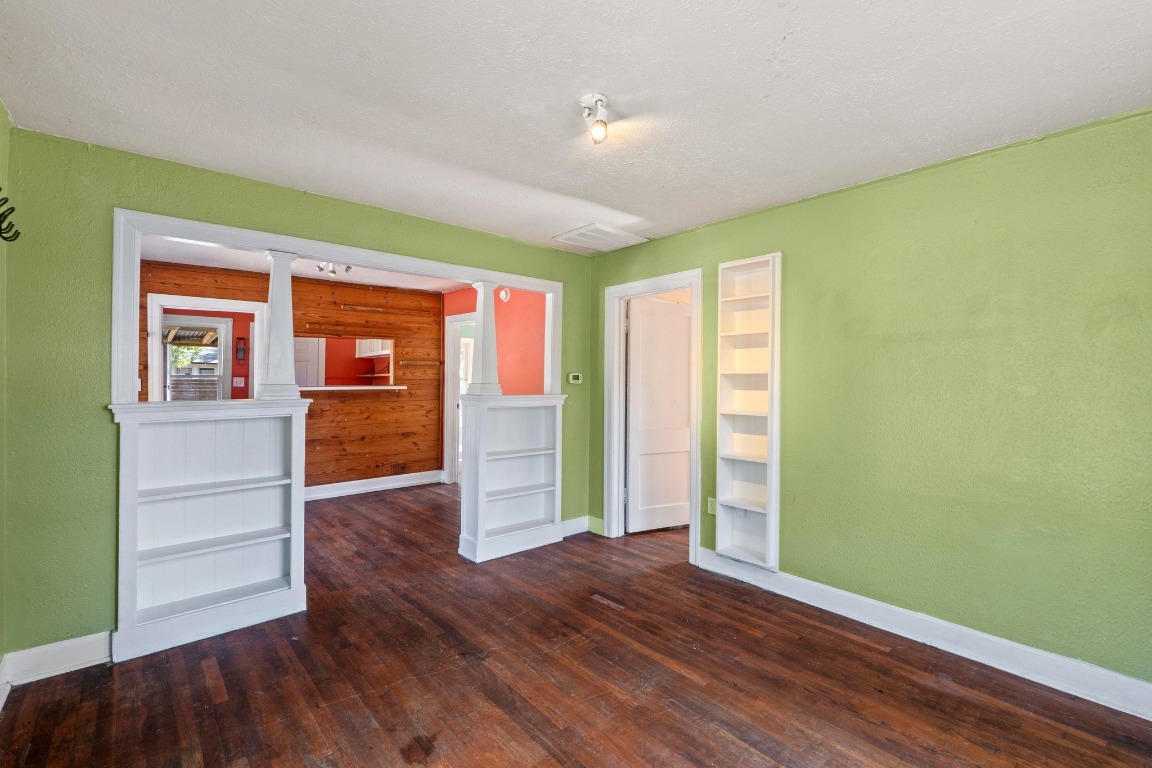 1147 Gunter Street Austin, TX 78721 - Photo 6 of 25 an empty room with wooden floor and windows