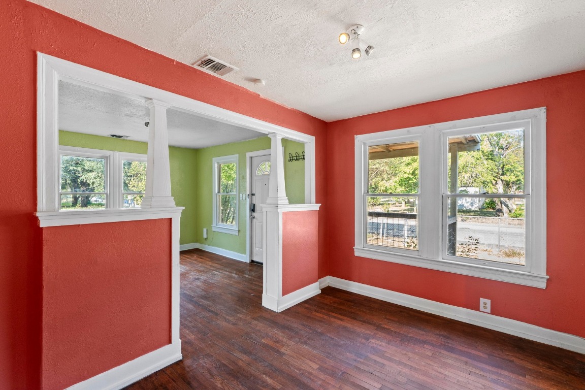1147 Gunter Street Austin, TX 78721 - Photo 7 of 25 a view of an empty room with a window and wooden floor