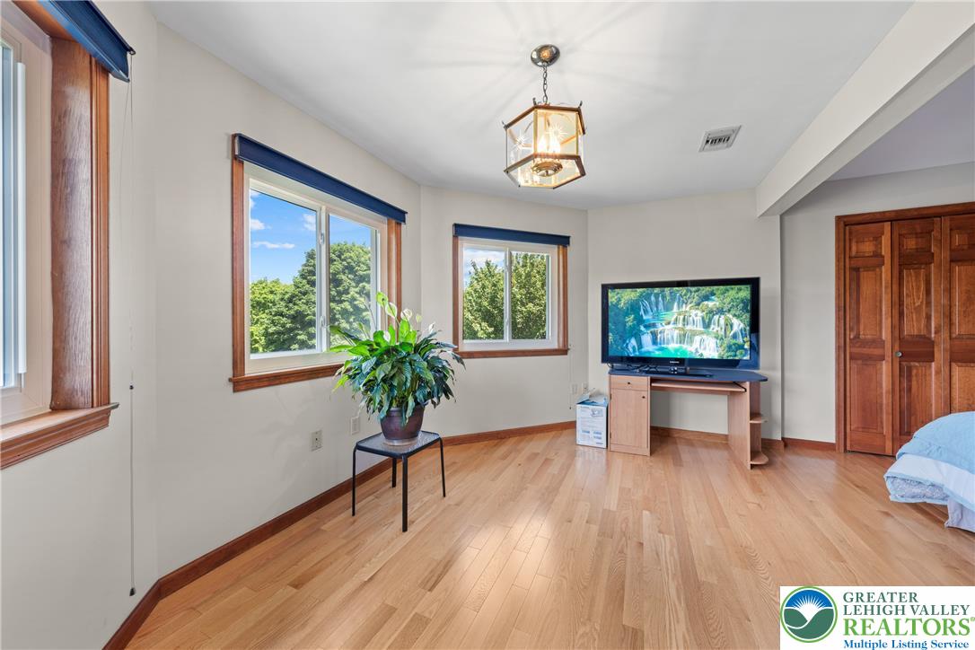 947 Tamenend Road Bath, PA 18014 - Photo 21 of 61 Hardwood floors and generous windows create a light-filled living space with vibrant outdoor views.