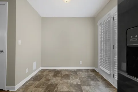a view of an empty room with a kitchen