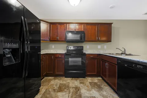 a kitchen with a refrigerator and a sink