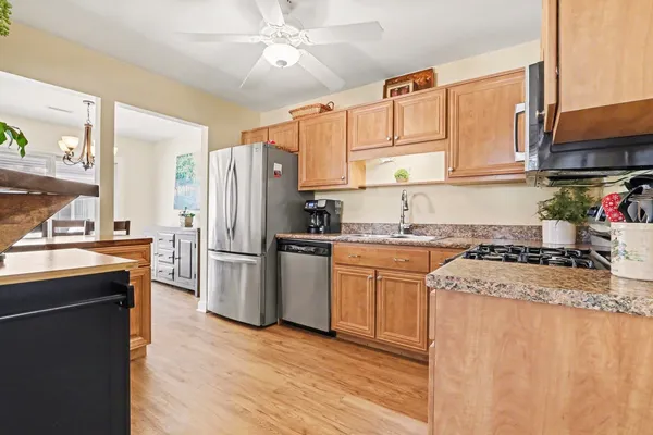 a kitchen with a refrigerator stove top oven and sink