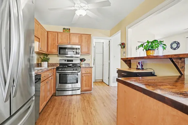 a kitchen with stainless steel appliances granite countertop a stove a sink and a refrigerator