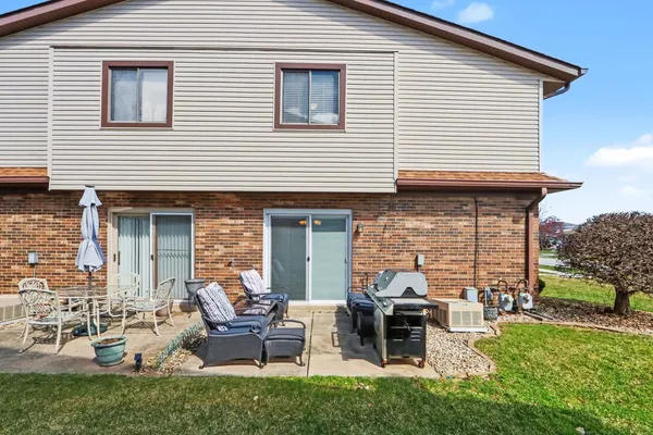 a view of a house with a chairs in patio
