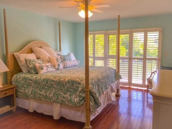 a bedroom with a large bed and a large window