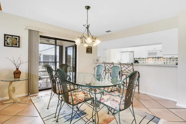 a view of a dining room with furniture and a chandelier