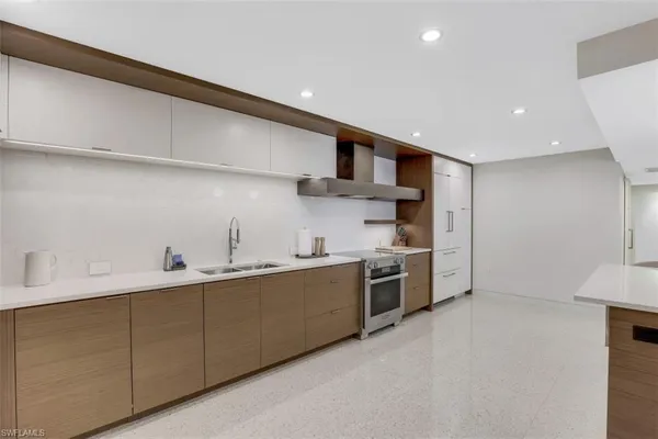 a kitchen with stainless steel appliances a sink stove and cabinets