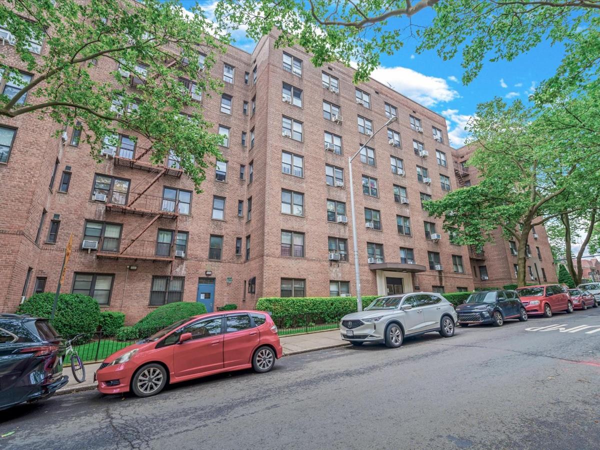 102-12 65th Avenue, Unit D22 Queens, NY 11375 - Photo 1 of 12 a car parked in front of a building